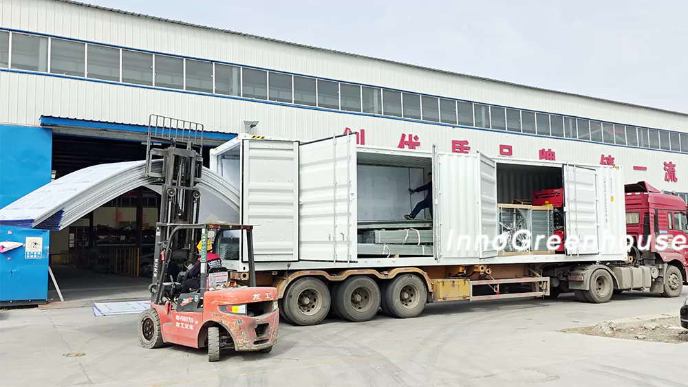 Loading greenhouse frame materials for shipment to Canada
